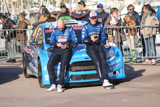 Monte-Carlo - JAN 24 : The pilot EVANS Elfyn and Co-driver PARRY Craig were sitting on the hood of their Ford Fiesta RS WRC2 on the port of Monaco. Monte Carlo Rally 2016, south of France on January 24, 2016 in Monte-Carlo, Monaco