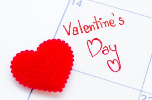 Small satin heart on calendar. Valentine's day concept.