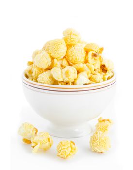 Popcorn in white bowl on white background.