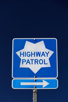 Roadside Highway Patrol sign with arrow pointing right.