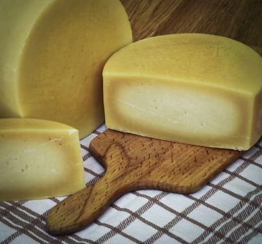 retro still life Round sliced hard cheese