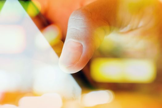 close up of Male fingers touching tablet screen double exposure and blurred view of car on street at night