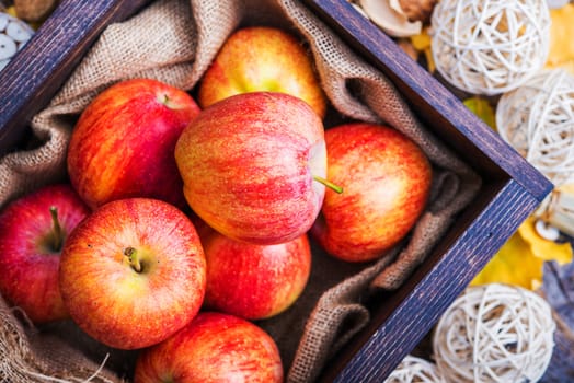 Fresh Red Apples in the Small Wooden Crate Closeup Photo. Organic Apples.