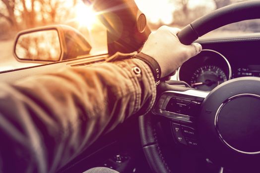 Hand on Wheel Car Driving.  Driving Modern Car Steering Wheel and the Hand Closeup.