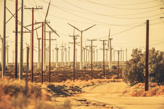 Palm Springs Sandy Gravel Desert Road and Wind Turbines. Palm Springs, California, USA.