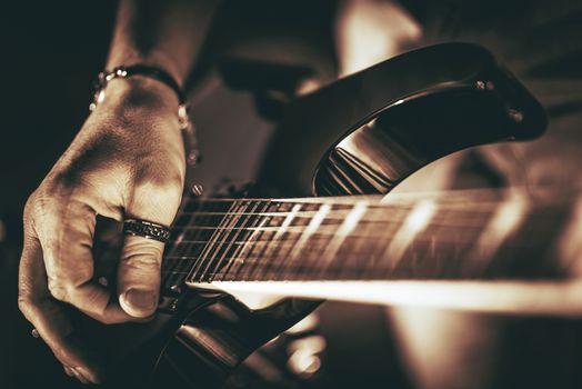 Guitarist Plays. Electric Guitar Playing Closeup Photo. Rockman Guitar Player Music Theme.