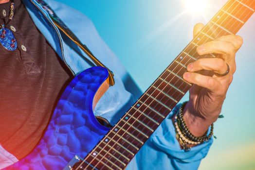 Rock Guitar Player. Men Playing Electric Guitar Closeup Photo.