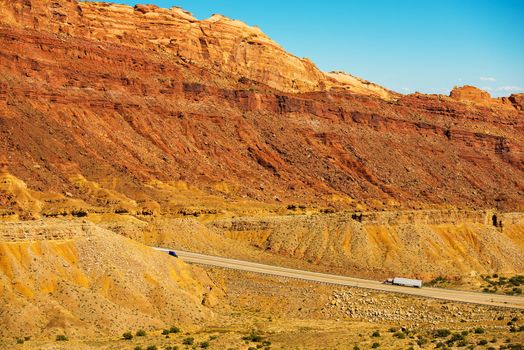 Trucks on the Utah Highway. Rocky Utah Wilderness Landscape. American Transportation Theme.