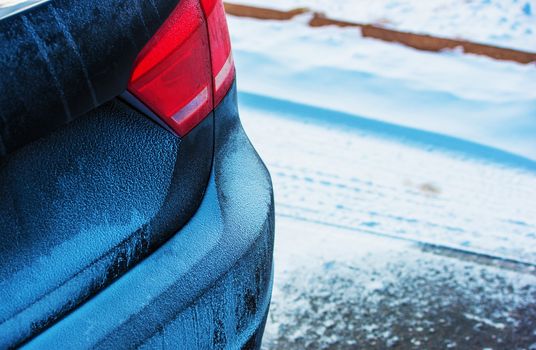 Winter Season Driving. Modern Sedan Car Covered by Snow. Car Closeup.