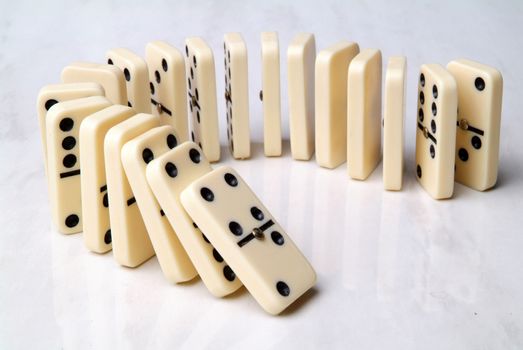 group of domino tiles in a semicircle shape on a neutral background