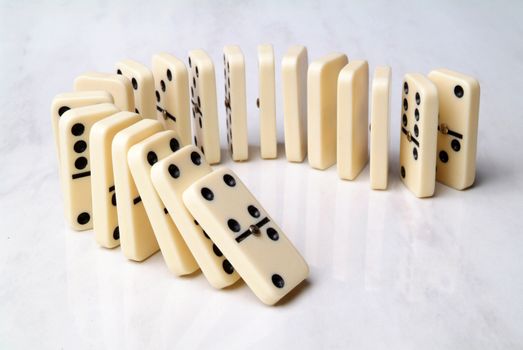 group of domino tiles in a semicircle shape on a neutral background