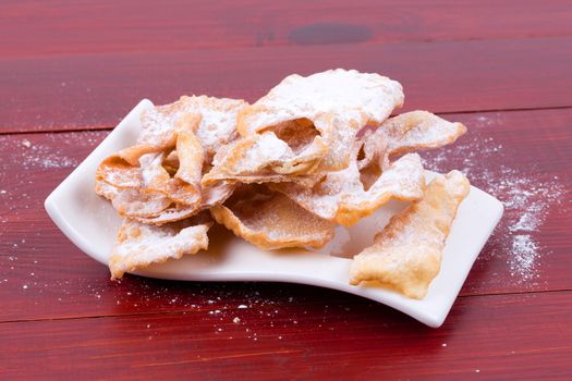 Bugnes - French donuts on a wooden background