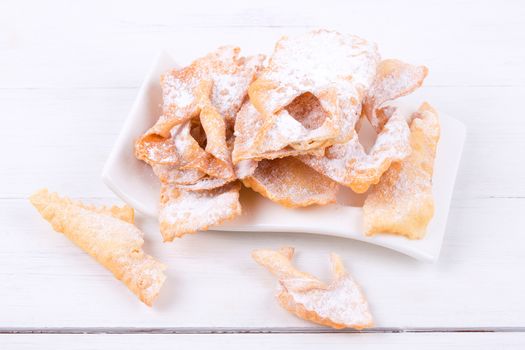 Bugnes - French donuts on a wooden background