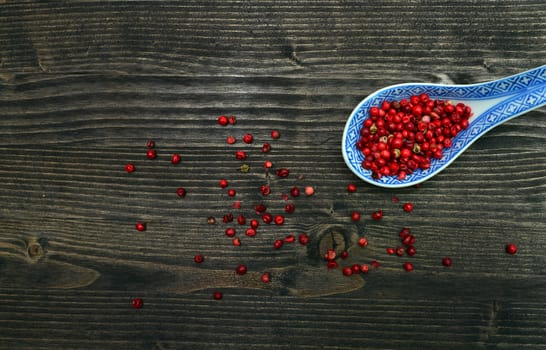 red pepper beans spoon over dark wood background