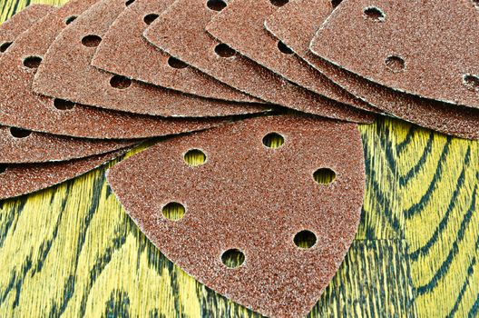 Detail of sandpaper on wooden background
