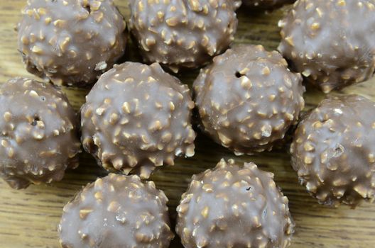 A variety of milk and dark chocolate truffles. on wooden background


