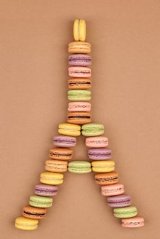 Macarons Eiffel Tower french sweet colorful. A lot of fresh  pastel delicious biscuit dessert on chocolate retro vintage background.                                           