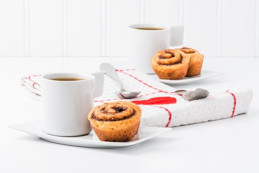Freshly baked cinnamon rolls served with coffee.