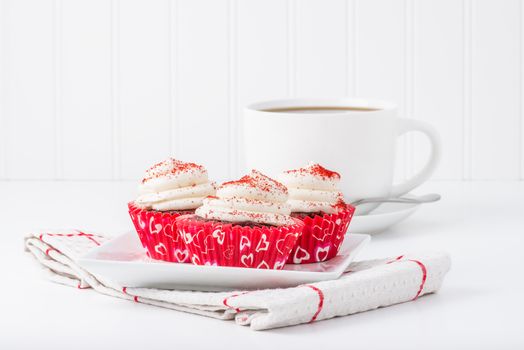 Valentines red velvet cupcakes served with hot coffee.