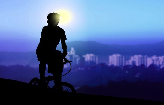 Mountain biker resting while watching sunrise