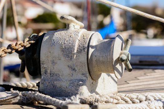 Fragmentary view details of knots and ropes on the yacht moored in the dock. Anchor Windlass Yacht