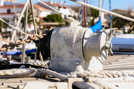 Fragmentary view details of knots and ropes on the yacht moored in the dock. Anchor Windlass Yacht.