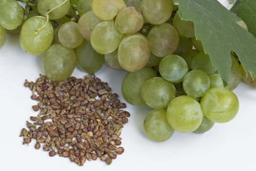 Grape and grape seeds on white background