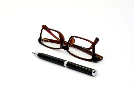 Black pen and brown glasses isolated on white background