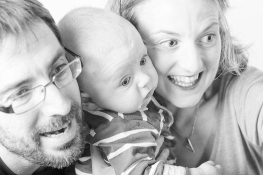 Happy and smiling portrait of Young Parents With Their Baby boy 4 month old Concept happy family