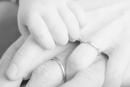 Father mother and baby holding hands family happiness balck and white