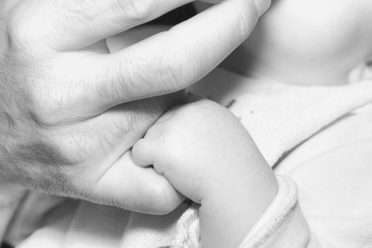 Father mother and baby holding hands family happiness balck and white