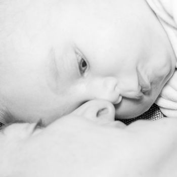 Beautiful newborn baby boy with his mother, complicity, happiness, black and white