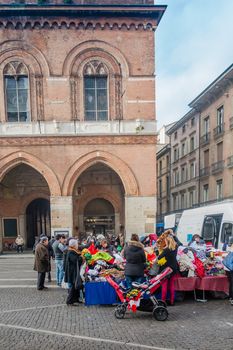 People shopping at street clothing vendor, Cremona open street market, January 2016 Italy