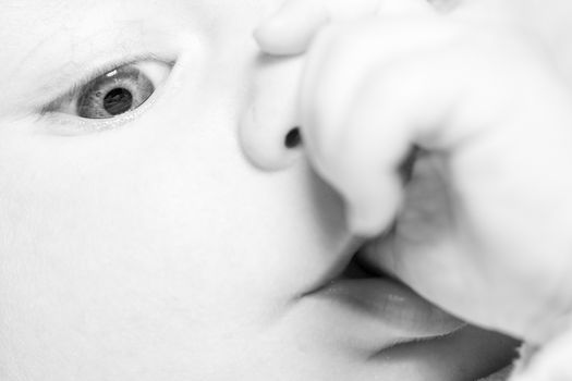 Newborn face eyes and nose,  close-up black and white, happiness