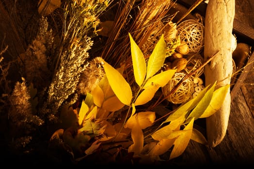 Autumn Floral Composition. Dried Plants, Dry Stalks and Leaves on Old Reclaimed Wood Planks. Fall Background Composition for Home Decoration.