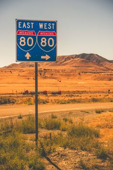American Interstate I-80 in Nevada State. Interstate Entrance Sign and Some Speeding Semi Truck.