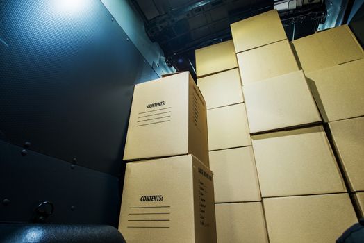 Pile of Boxes in a Cargo Van Closeup. Products Transportation Industry. Shipping and Delivery.