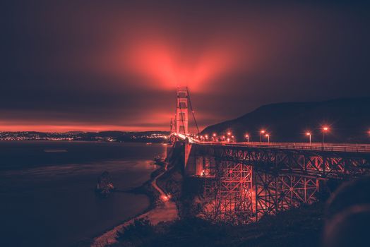 San Francisco Bay and th Golden Gate Bridge in the Fog. Night Panorama with Reddish Color Grading.