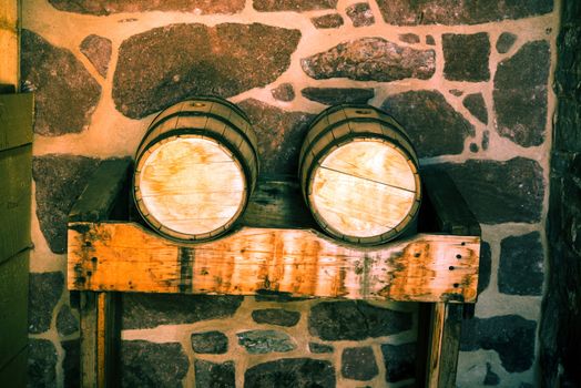 Wine Wooden Barrels on Wooden Stand. Winery Interior.