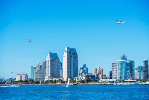 Summer in the San Diego. San Diego Skyline and Military Choppers on the Sky.