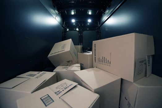 Cardboard Moving Boxes in the Large Commercial Van Cargo Area. 