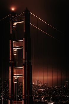 San Francisco California, United States. Famous Golden Gate Bridge and San Francisco Skyline at Night. Reddish Brown Color Grading.