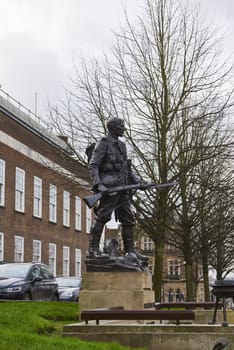 TUNBRIDGE WELLS, UK - JANUARY 26: Side shot of bronze War memorial depicting soldier holding rifle. January 26, 2016 in Tunbridge Wells.
