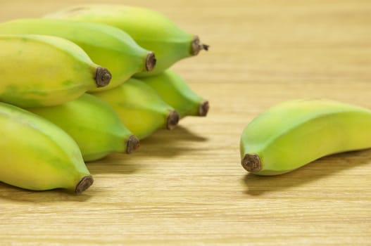 Pisang Awak banana vegetarian food in Thailand on wood background.