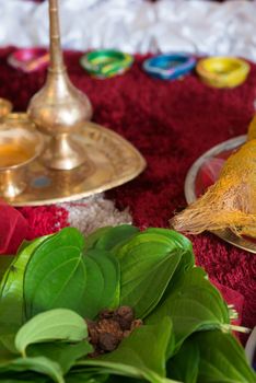 Traditional Indian Hindu religious praying items in ear piercing ceremony for children. Focus on the betel leaves.
