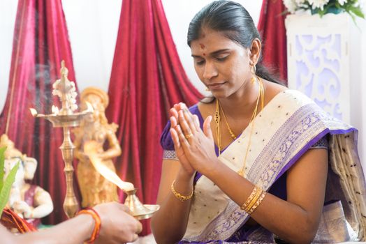 Woman received prayers from priest. Traditional Indian Hindus ear piercing ceremony. India special rituals.