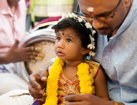 Baby girl received prayers from the karnvedh events. Traditional Indian Hindus ear piercing ceremony. India special rituals.