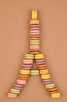 Macarons. Still life. Eiffel Tower french sweet colorful. A lot of fresh  pastel delicious biscuit dessert on chocolate retro vintage background.                                           