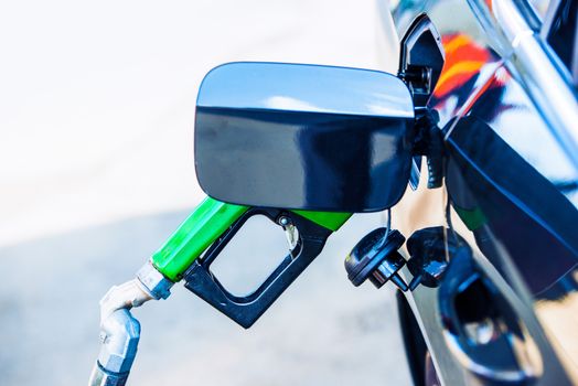 Car Fueling at Gas Station. Green Diesel Nozzle.