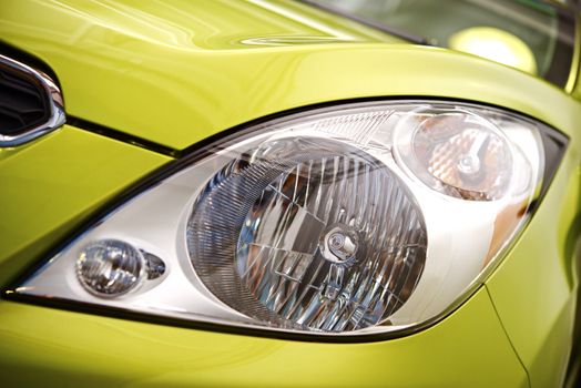 Clean Compact Car Headlight Closeup Photo.